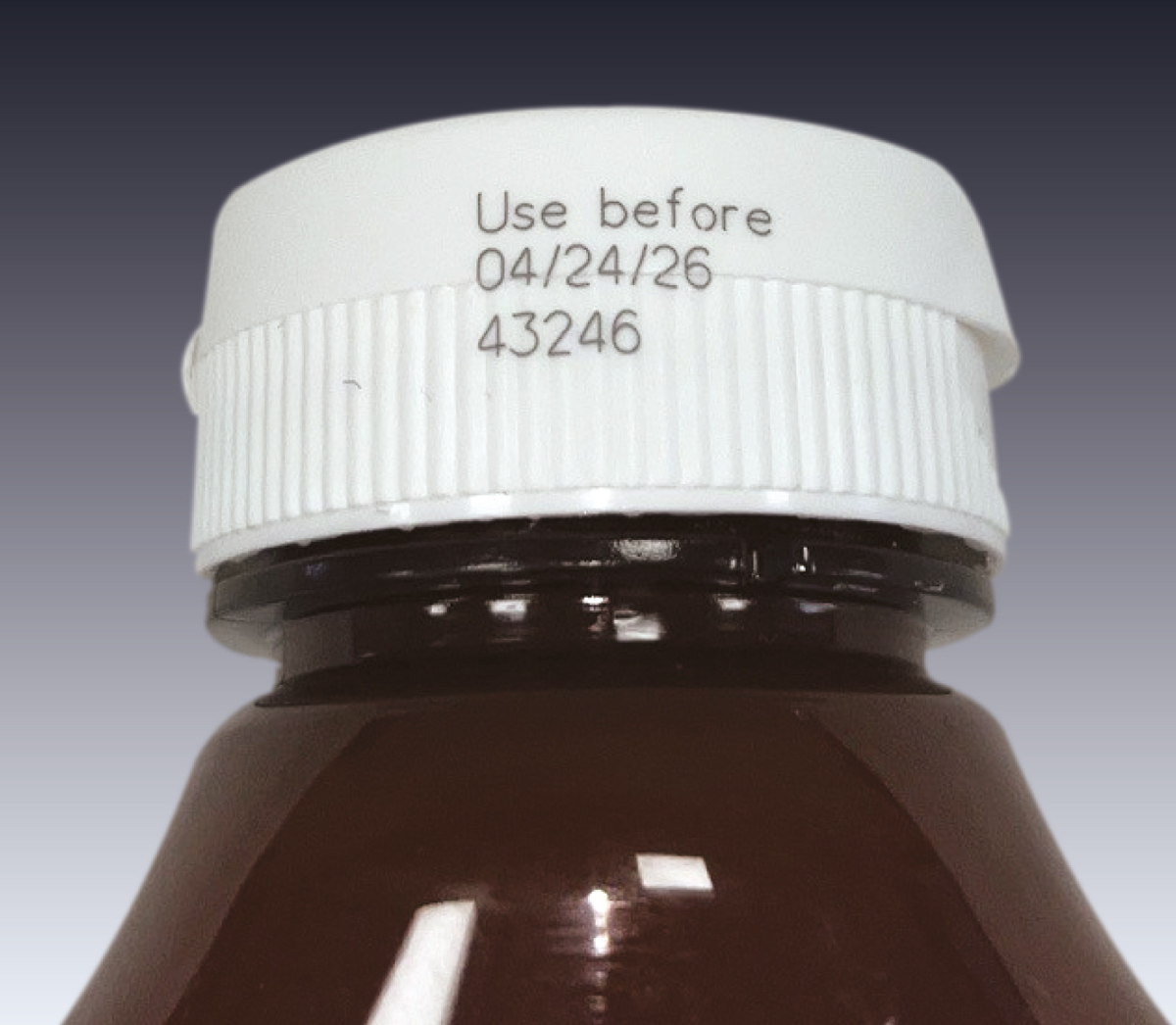 CIJ product marking: two line alpha-numeric code in yellow ink on a black plastic tray