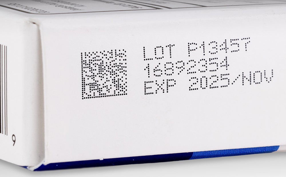 Videojet 1880 continuous inkjet printer applying lot number printing on pharmaceutical paperboard packaging.