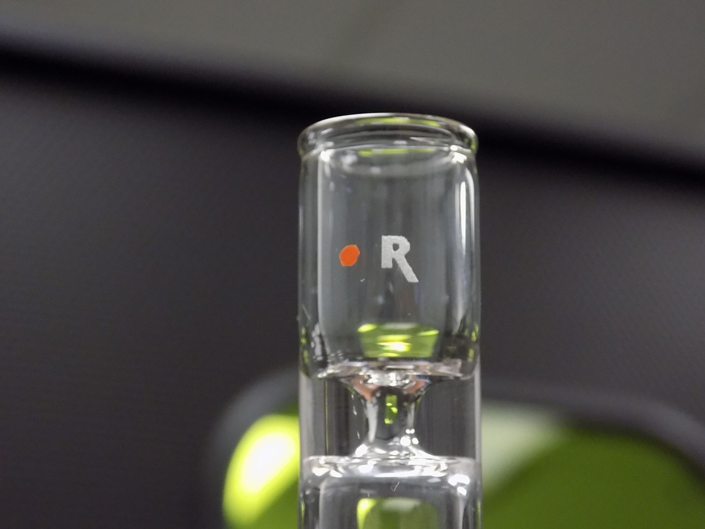 Videojet laser-etched image on glass vial – shallow, readable mark with minimal surface disruption.